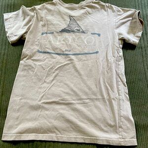 tan aftico tee with light blue on the back
